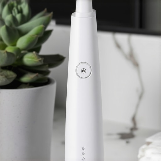 A water flosser and electric toothbrush on a bathroom counter