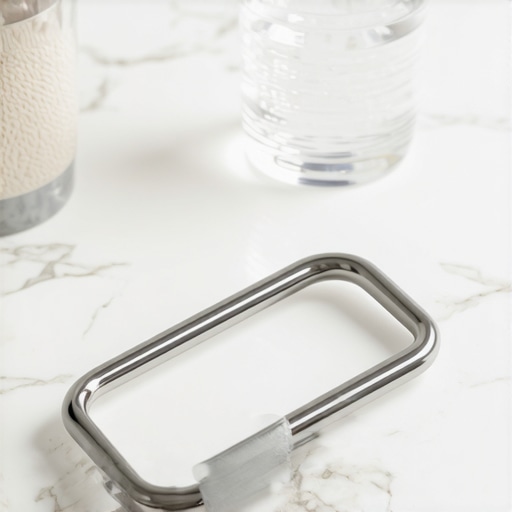 Stainless steel tongue scraper and bamboo toothbrush on a marble surface.